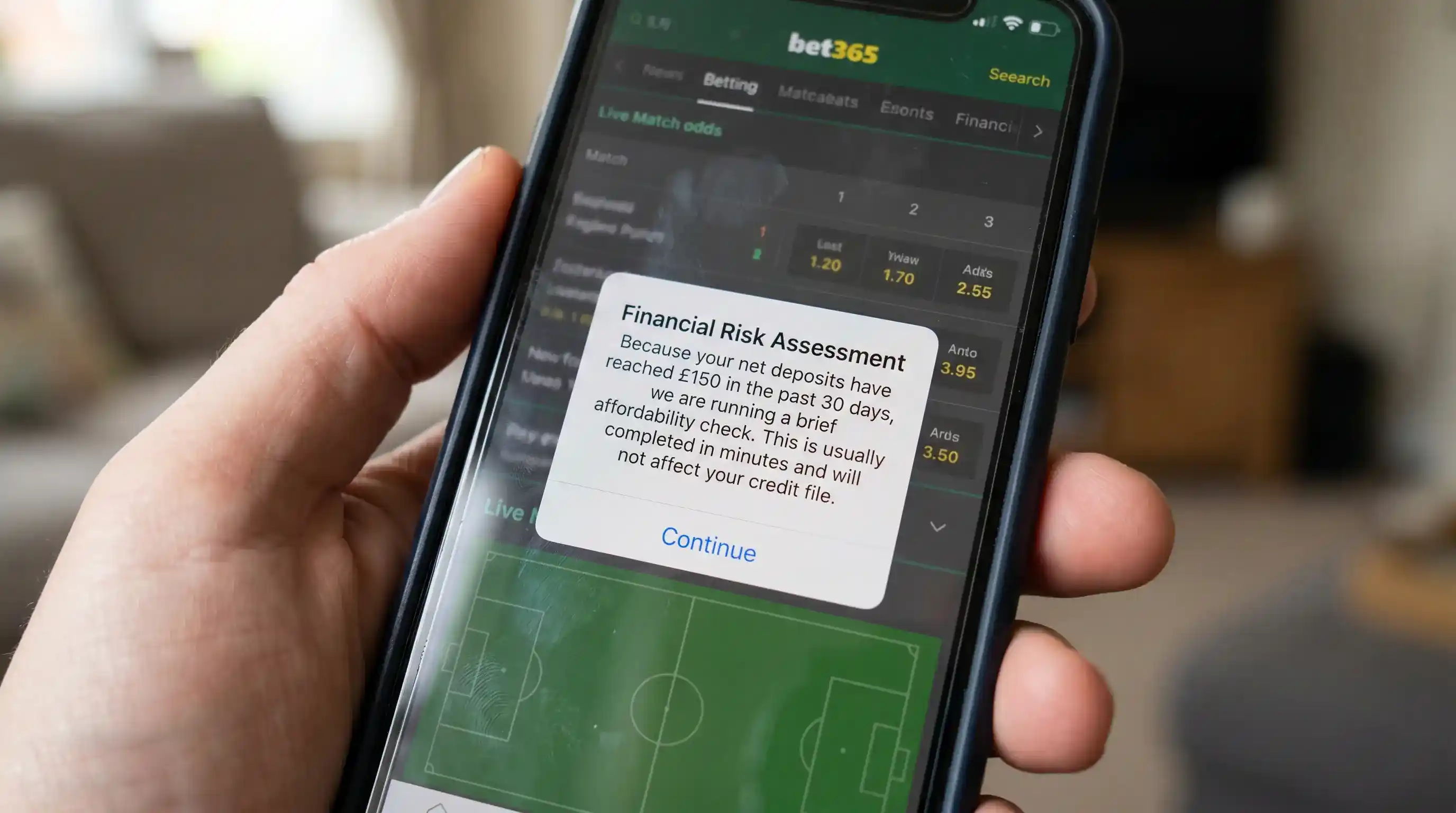 A Financial Risk Assessment in-app notification appearing on a UK football bookmaker mobile screen after the £150 threshold