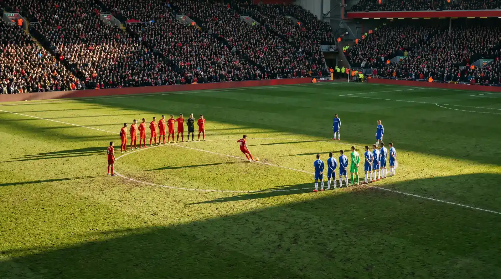 Premier League first-half kick-off showing both sides taking their initial tactical positions on the pitch