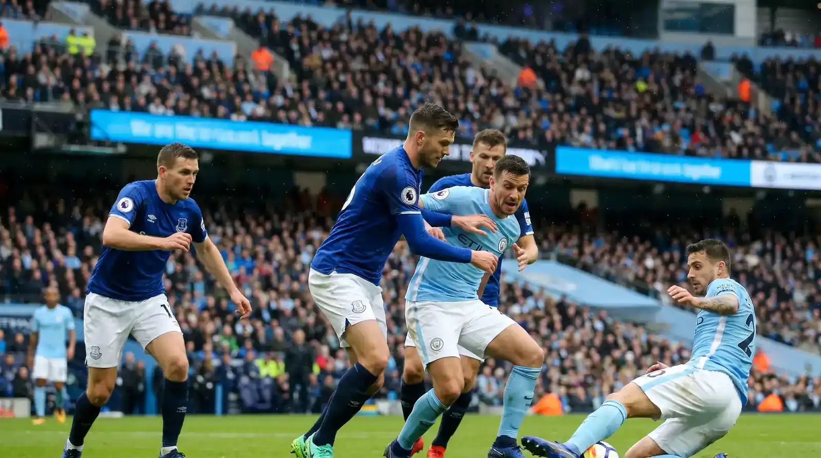 Premier League attacking team pressing in the opposition penalty area with multiple shirts in the box against a sparse defence